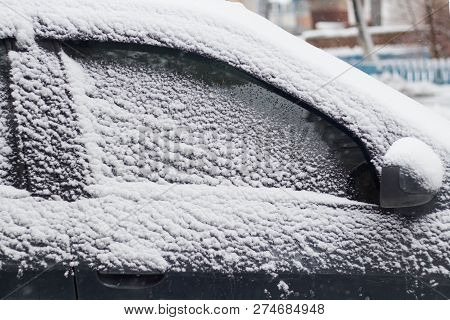 Side Windows Of A Car In The Snow Close Up