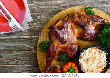Whole Baked Flattened Chicken With A Golden Crispy Crust With Fresh Vegetables, Herbs And Cabbage Sa