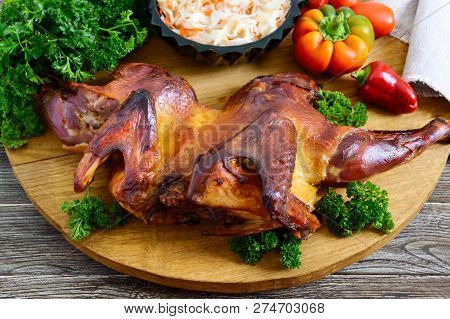 Whole Baked Flattened Chicken With A Golden Crispy Crust With Fresh Vegetables, Herbs And Cabbage Sa
