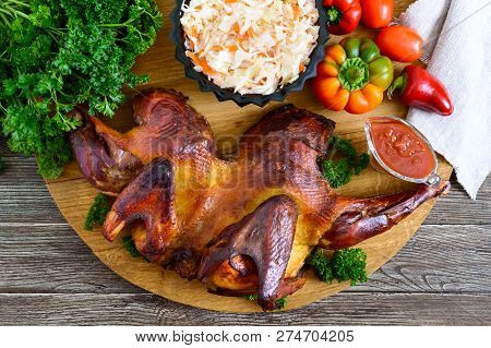 Whole Baked Flattened Chicken With A Golden Crispy Crust With Fresh Vegetables, Herbs And Cabbage Sa
