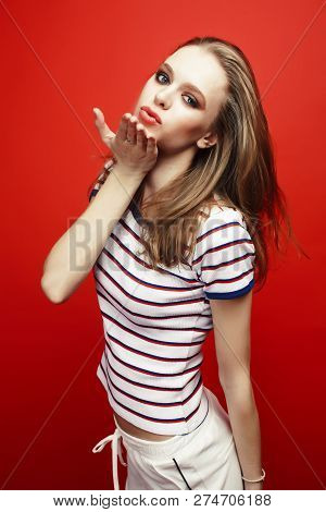 Young Pretty Teenage Girl On Bright Red Background, Happy Smilin