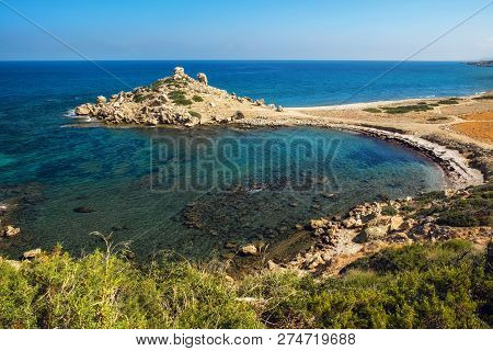 Small Alagadi Beach Panorama With Peninsula And Dry Pasture