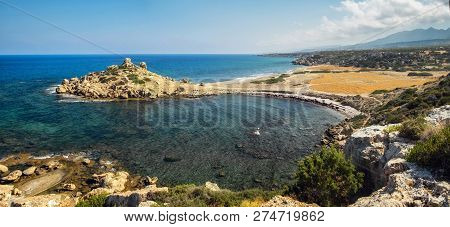 Small Alagadi Beach Panorama With Peninsula And Dry Pasture