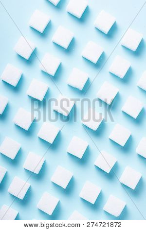 Sugar Cubes Pattern Over Blue Background, Flat Lay Scene