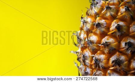 Close-up Of The Edge Of A Ripe Pineapple On A Yellow Background. Freespace. Copy Space.