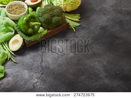 Assorted Green Toned Raw Organic Vegetables On Dark Background. Avocado, Cabbage, Broccoli, Cauliflo