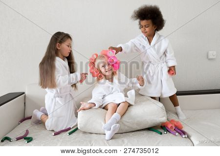Little Girls Play With Hair Curlers And Hairpins.