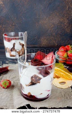 Chocolate Cookies, Cream And Strawberry Dessert In A Glass On A Darkbackground , Delicious Trifle, C