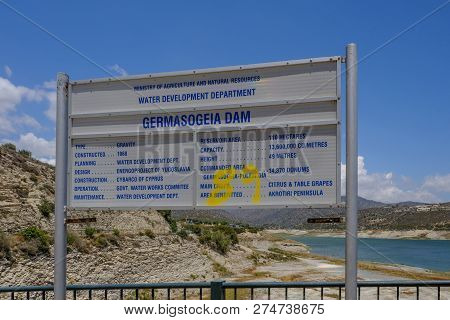 Germasogeia, Cyprus - June 18, 2018: Sign For Germasogeia Dam Prominent In The Shot With The Water A