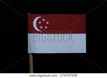 A Official Bicolour Flag Of Singapore On Toothpick On Black Background. A Horizontal Bicolour Of Red