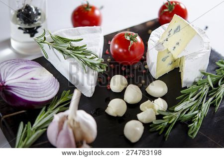 Tasting Cheese Dish With Tomatos On Old Black Dask. Food For Wine And Romantic, Cheese Delicatessen.