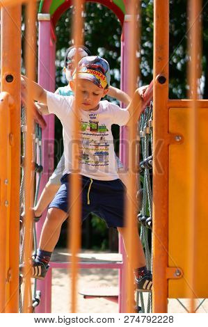 Poznan, Poland - July 29, 2018: Young Boy Climbing On A Climb Equipment At A Playground On The Cytad