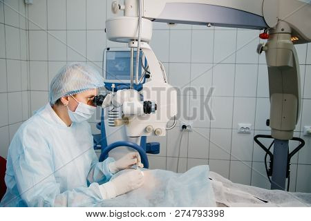 Surgeon With Operating System Of Laser Vision Correction In The Operating Room. Ophthalmology Operat