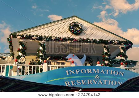 Orlando, Florida. November 19, 2018. Information And Reservation Sign And Christmas Ornaments On Lig