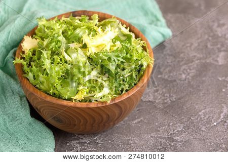 Fresh Frisee Salad In Wooden Bowl. Healthy Food