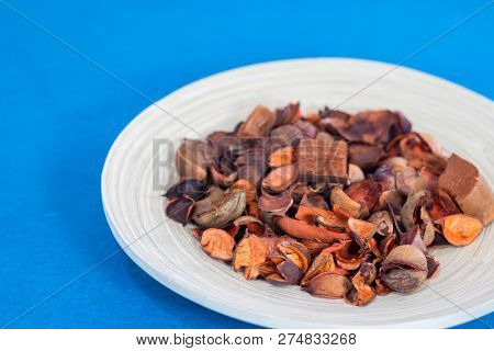 Potpourri In The Wooden Plate With Blue Background