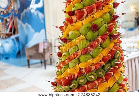 Tropical Fruits Cut Thtower Of Chopped Tropical Fruits And Strawberries At The Banquet. Appetizer At