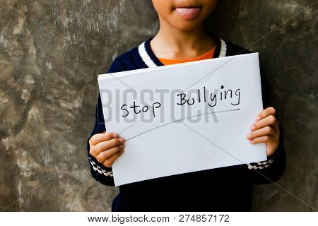 Girl With Stop Bullying Sign, Stop Bullying Concept. Bullying Is Unwanted And Aggressive Behavior. I