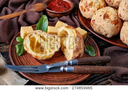 Close-up Of Gougeres, Cheese Puffs Balls Cut In Halves On A Earthenware Plate. Classic French Cheese