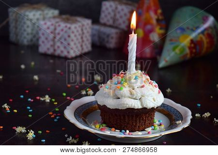 Chocolate Cupcake With Vanilla Cream And Candle. Happy Birthday. Dark Photo