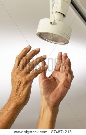 Electric Male Hand Lamps With Ceiling Led Lamp, Spotlight. The Concept Of Repair And Maintenance.