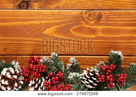 Spruce Branches, Cones And Red Berries On A White Wooden Background. Background For Christmas And Ne