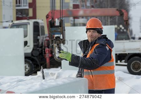 Slinger In An Orange Helmet On Unloading Ice Blocks