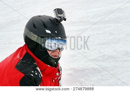 Snowboarder Or Skier Portrait In Sport Goggles And Protection Helmet With Mounted Action Camera And 