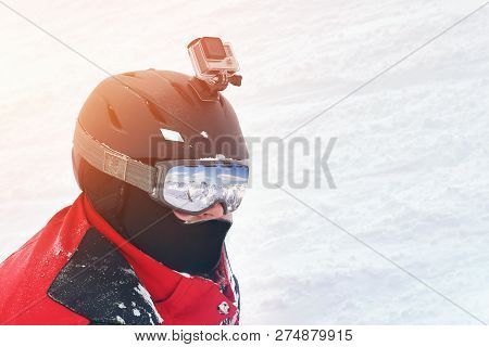 Snowboarder Or Skier Portrait In Sport Goggles And Protection Helmet With Mounted Action Camera And 