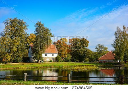 Country Estate Near The Lake And Forest, Sunny Autumn Day.  Leaf Fall Landscape.