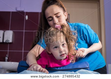 Physiotherapy In Medicine Clinic With A Baby Having A Cerebral Palsy.