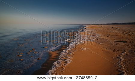 Sea Foam At The Beach Of The Aral Sea Near Aktumsuk Cape At Sunset In Karakalpakstan, Uzbekistan