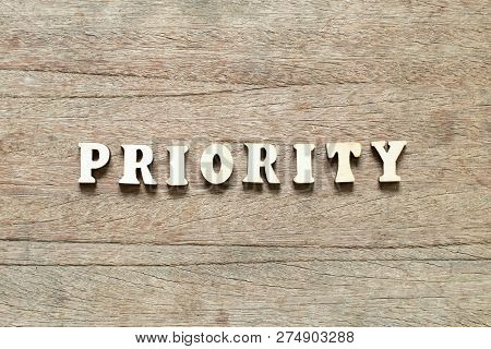 Letter Block In Word Priority On Wood Background