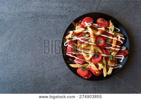 Homemade Peruvian Salchipapa Fries With Sausage Slices, Ketchup And Mayonnaise.