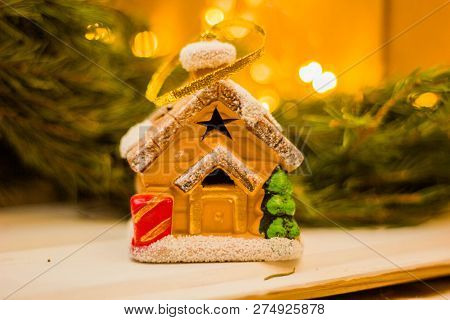 Christmas Gingerbread House On A Wooden Background And Christmas Tree