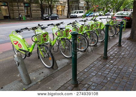 BUDAPEST, HUNGARY - JULY 2018 : Green bicycles from MOL BuBi docking by street in Budapest, Hungary on July 18, 2018. Bubi is a bicycle sharing network in Hungary. 