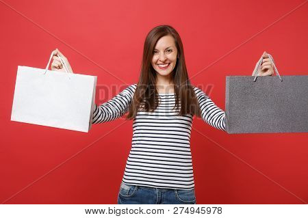 Portrait Of Smiling Young Woman In Striped Clothes Holding Packa