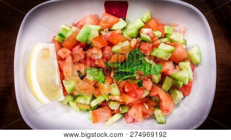 Turkish Coban Salata Or Shepherds Salad In White Bowl At Restaurant