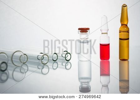 Group Of Vials With Medication On Blue Methacrylate Table. Horizontal Composition.