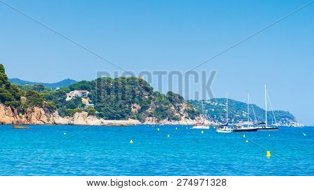Yachts And Boats Near Coastline Sea In Ibiza. Seascape In Spain. Rocky Coastline In Spanish Mediterr