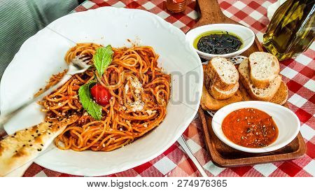Spaghetti Napolitan Or Bolognese Served With Tomato And Olive Paste. Italian Food Concept.