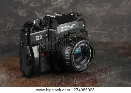 MOSCOW, RUSSIA, DECEMBER 21, 2018. The old Soviet 35 mm SLR camera Zenit 122, released 2001, on gray-brown cement background.