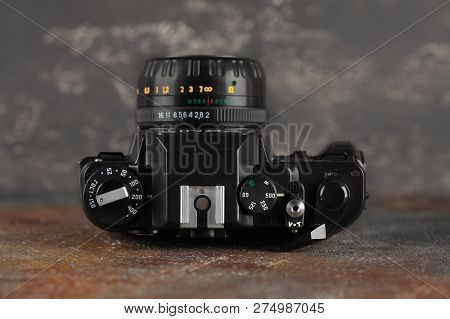MOSCOW, RUSSIA, DECEMBER 21, 2018. The old Soviet 35 mm SLR camera Zenit 122, released 2001, on gray-brown cement background.