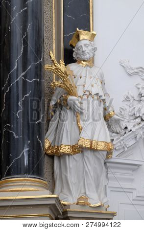 WURZBURG, GERMANY - JULY O4, 2018: Saint John Nepomuk statue on the The Deanâs Altar in Wurzburg Cathedral dedicated to Saint Kilian, Bavaria, Germany