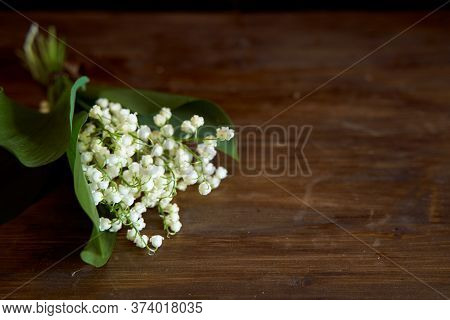 A Bouquet Of Lyses On A Wooden Table. With Copy Space.