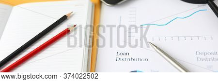 Close-up Of Important Documents Of Loan Distribution. Graph And Bar Chart. Datebooks With Notes, Pen