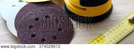 Close-up Of Sander Machine With Replacement Discs On Table. Grinding Equipment For Renovation And Co