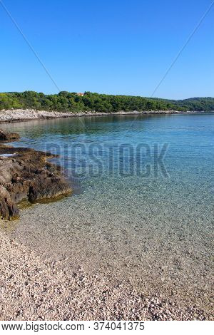 Turquoise Sea Water White Stone Beach And Mountains, Sumartin, Brac Island, Croatia
