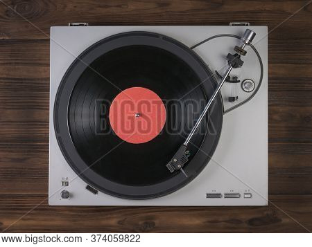 Vinyl Record Player On A Wooden Background. The View From The Top. Music On Vinyl Discs.
