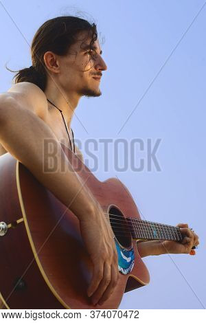 Guitarman Stay With Guitar In Front Of The Sky